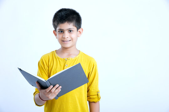 young indin boy holding a notebook 