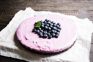 Fresh blueberry cheesecake on the rustic background. Selective focus. Shallow depth of field.