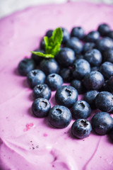 Fresh blueberry cheesecake on the rustic background. Selective focus. Shallow depth of field.