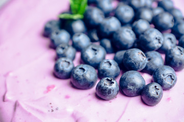 Fresh blueberry cheesecake on the rustic background. Selective focus. Shallow depth of field.
