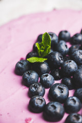 Fresh blueberry cheesecake on the rustic background. Selective focus. Shallow depth of field.