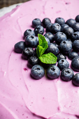 Fresh blueberry cheesecake on the rustic background. Selective focus. Shallow depth of field.