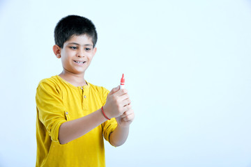 young indian child showing a pen, marker