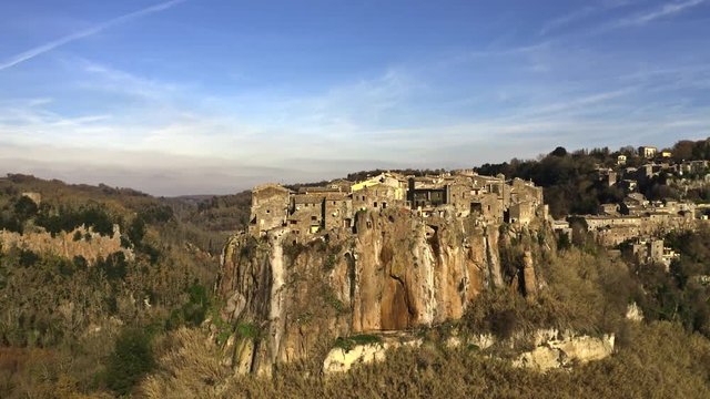 Aerial revealing shot of town of Calcata on high rock. Lazio, Italy