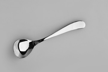 Spoon on a gray background used in restaurants