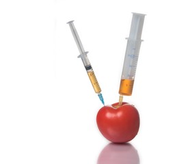 Injection into a tomato, GMO concept, pesticides, poisons. White background.