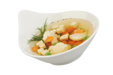 Vegetable soup with cauliflower, potatoes, peas, carrots and dill on a white isolated background