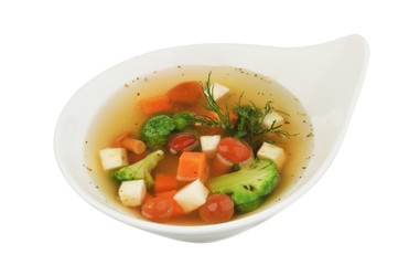 Vegetable soup with cauliflower, potatoes, peas, carrots and parsley on a white isolated background