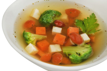 Vegetable soup with cauliflower, potatoes, peas, carrots and parsley on a white isolated background