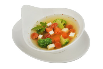 Vegetable soup with cauliflower, potatoes, peas, carrots and parsley on a white isolated background