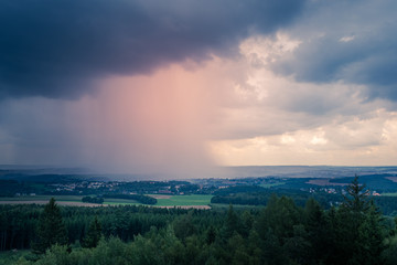 Fototapeta na wymiar Stormy evening weather over rolling hills