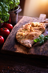 homemade calzone on a wooden board