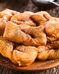 Traditional Chilean sweet calzones rotos deep-fried pastries sprinkled with powdered sugar served...