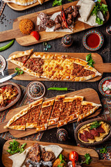 Traditional Turkish cuisine. Pizza, pita, pidesi, sucuk, hummus, kebab, bulgar. Many dishes on the table. Serving dishes in restaurant. Background image. Top view, flat lay