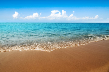 Summer background of sea with sand and blue sky. Free space for your decoration. 