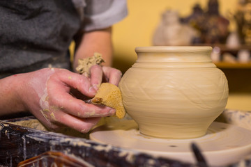 Professional potter shaping pot