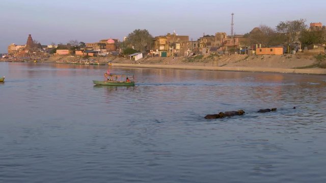Ganga river ghat with boats in India, Vrindavan, 4k aerial drone sunset