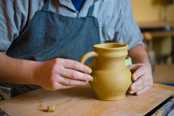 Fototapeta na wymiar Professional male potter working in workshop, studio