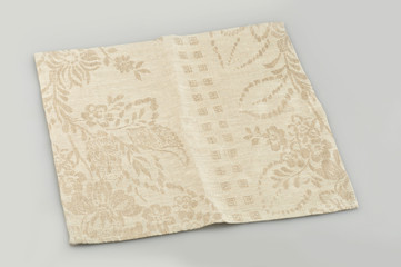 Beige cloth napkin on a gray background
