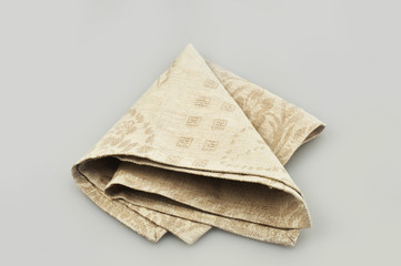 Beige cloth napkin on a gray background