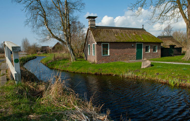 Fototapeta na wymiar Tiny house at National Park Weerribben Overijssel Netherlands. Moor and peatfields