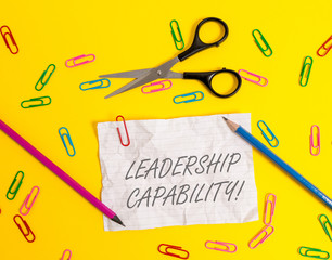 Writing note showing Leadership Capability. Business concept for what a Leader can build Capacity to Lead Effectively Crushed striped paper sheet scissors pencils clips colored background