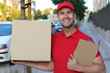 Delivery man holding a box outdoors