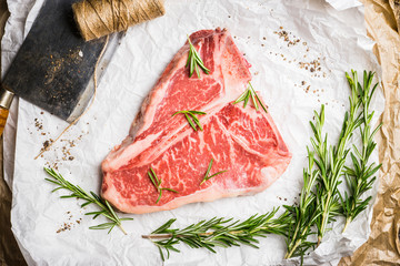 Raw fresh marble T-bone meat on the rustic background. Selective focus. Shallow depth of field.