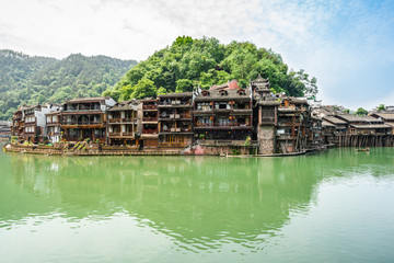 Fototapeta na wymiar Old traditional houses on riverside landscape in Fenghuang ancient phoenix town Hunan China