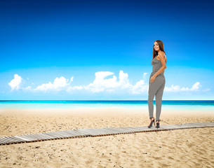 Slim young woman on beach and summer time 