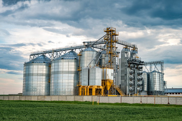 agro-processing plant for processing and silos for drying cleaning and storage of agricultural products, flour, cereals and grain with beautiful clouds