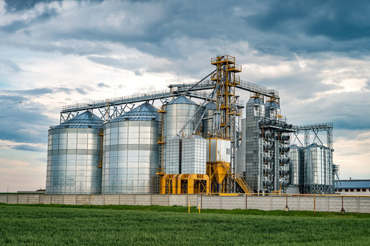 agro-processing plant for processing and silos for drying cleaning and storage of agricultural products, flour, cereals and grain with beautiful clouds