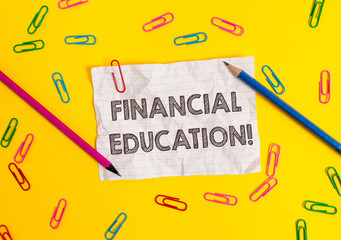 Conceptual hand writing showing Financial Education. Concept meaning Understanding Monetary areas like Finance and Investing Blank crushed paper sheet message pencils colored background