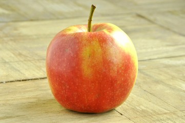 red apple on wooden table
