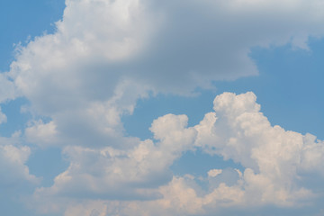 White clouds in the blue sky. Atmospheric phenomenon.