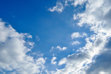 Naklejka na ściany i meble Heavenly sky with clouds and rays of sunlight