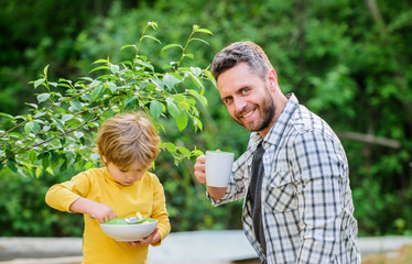 Obraz premium Nutrition kids and adults. Healthy nutrition concept. Menu for children. Nutrition habits. Family enjoy homemade meal. Healthy breakfast. Father son eat food and have fun. Little boy and dad eating