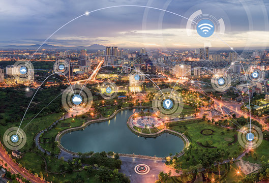 Smart city and wireless communication network concept. Digital network connection lines of Hanoi city at twilight period. Cau Giay park, west of Hanoi