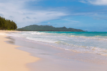 Beautiful Waimanalo beach with turquoise water and cloudy sky, Oahu coastline, Hawaii
