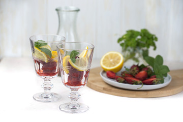 A glass of detox water. Strawberry, lemon and mint with cool clean water.