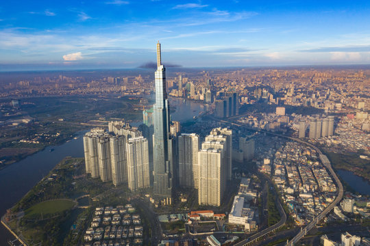 Top View of Building in a City - Aerial view Skyscrapers flying by drone of Ho Chi Mi City with development buildings, transportation, energy power infrastructure. include Landmark 81 building 