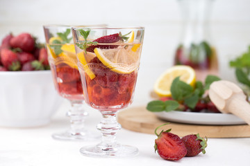 A glass of detox water. Strawberry, lemon and mint with cool clean water.