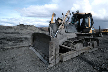 Heavy bulldozer with open door on mining