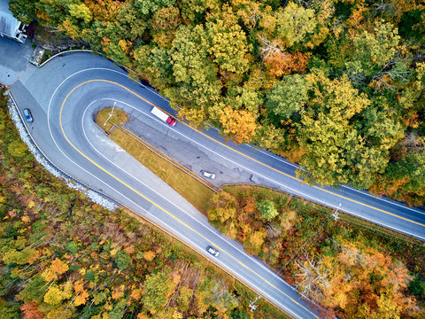 Scenic Mohawk Trail highway hairpin turn in autumn, Massachusetts, USA. Fall in New England. Aerial drone shot.