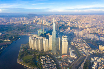 Fototapeta na wymiar Top View of Building in a City - Aerial view Skyscrapers flying by drone of Ho Chi Mi City with development buildings, transportation, energy power infrastructure. include Landmark 81 building 