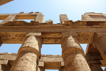 Hieroglyphs and ancient symbols on the columns of the Temple of Karnak, landmark of Egypt in Luxor