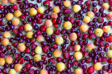 Still life, composition of fruits and berries. Juicy, ripe fruits and berries, apricots, strawberries, cherries, cherries. Berries for the desktop.