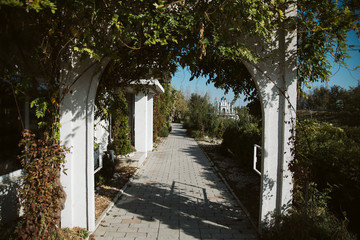 Alley in the park. Garden and the gate