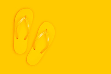Flip flop slippers with copy space on yellow background