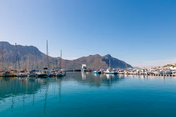 Tuinposter Hout Bay boats and mountain reflections morning view © Dmitrii